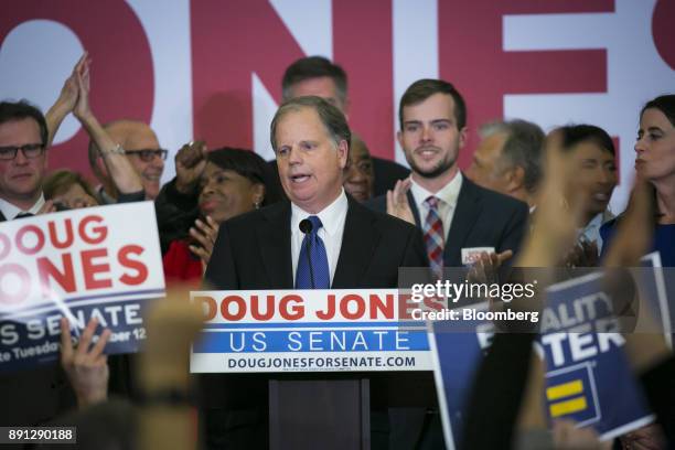 Attendees cheer as Senator-elect Doug Jones, a Democrat from Alabama, center, addresses the audience at an election night party in Birmingham,...