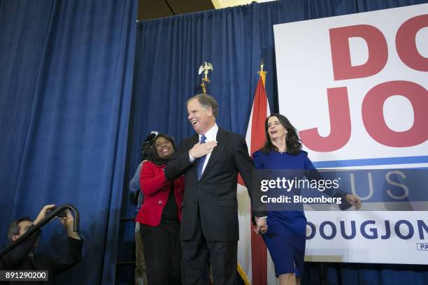 Senator-elect Doug Jones, a Democrat from Alabama, center, and wife Louise Jones, right, greet the audience at an election night party in Birmingham,...