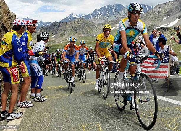 Andreas Kloeden of Germany and team Astana leads his teammate and race leader Alberto Contador of Spain in his yellow jersey up the Col du...