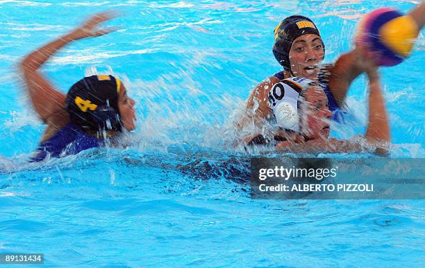 Brazilian Marina Canetti and Marina Zablith fights for the ball with German Nina Wengst during the Women's water-polo preliminary round Group D match...