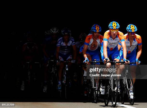 Bradley Wiggins of Great Britain and team Garmin - Slipstream rides with his teammates up the Col du Grand-Saint-Bernard during stage 16 of the 2009...