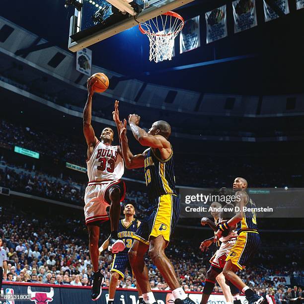 Scottie Pippen of the Chicago Bulls shoots a layup against Antonio Davis of the Indiana Pacers in Game Five of the Eastern Conference Finals as part...