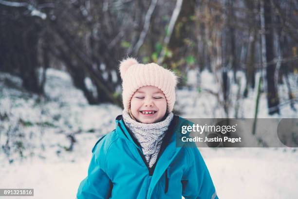 excited young girl in snow - winter coat stock pictures, royalty-free photos & images