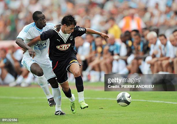 Bordeaux Moroccan forward Marouane Chamakh vies with Marseille Senegalese defender Souleymane Diawara , on July 21 during the friendly football match...