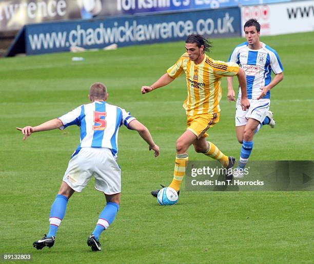 Andy Carroll in action during a pre-season friendly match between Huddersfield Town and Newcastle United at the Galpharm Stadium on July 21, 2009 in...