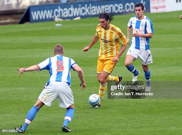 Andy Carroll in action during a pre-season friendly match between Huddersfield Town and Newcastle United at the Galpharm Stadium on July 21, 2009 in...