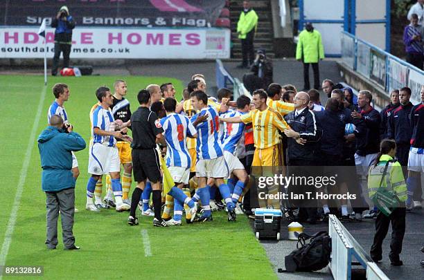 Players confront each other after the half time whistle during a pre-season friendly match between Huddersfield Town and Newcastle United at the...