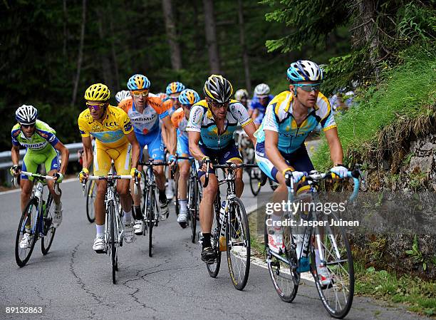 Race leader Alberto Contador of Spain and team Astana climbs in the yellow jersey with his teammates Lance Armstrong of USA and Sergio Paulinho of...