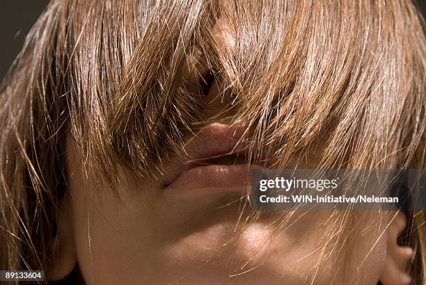 close-up of a young woman's eyes covered with her hair - woman full frame stock pictures, royalty-free photos & images