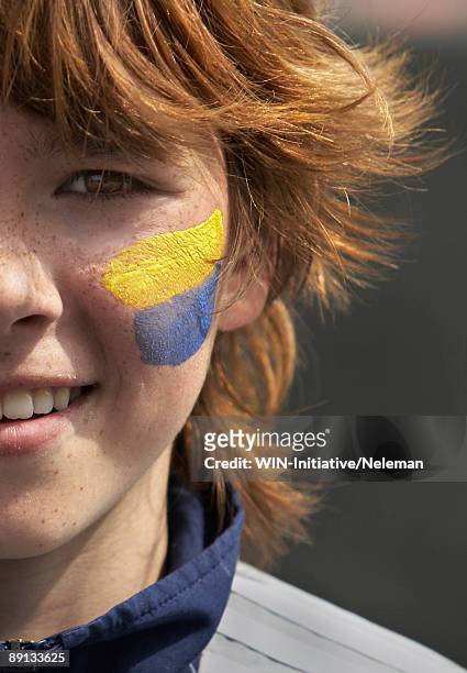 portrait of a boy with a ukrainian flag painted on his cheek, kiev, ukraine - faces of a nation stock-fotos und bilder