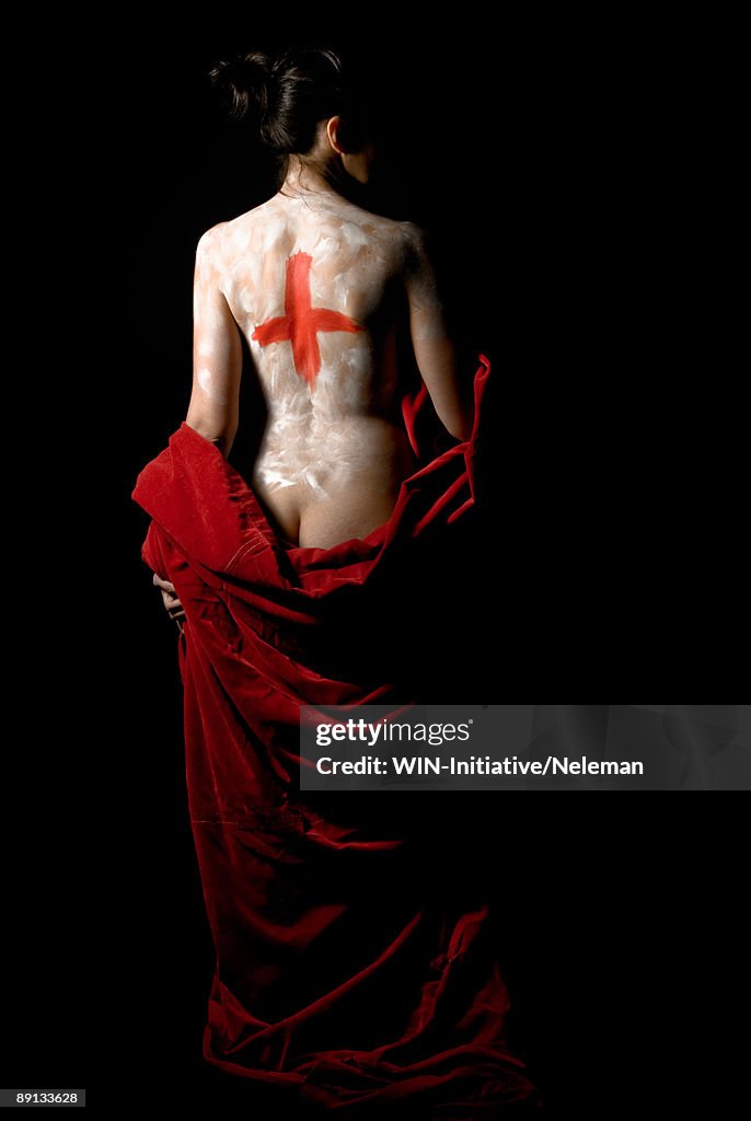 Woman's back with a red cross and a red cloth