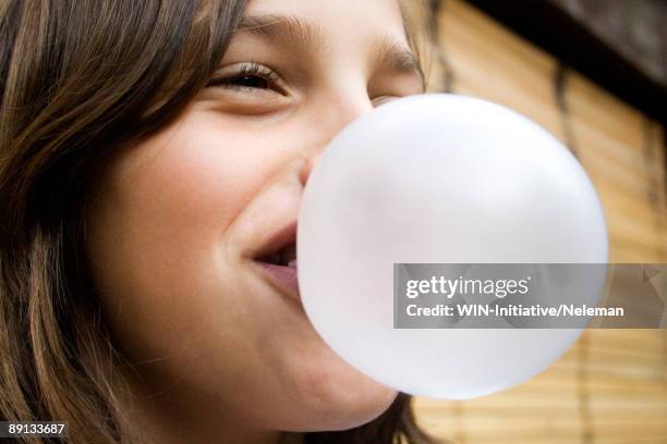 close-up of a girl blowing a bubble gum, uruguay - kauwgom stockfoto's en -beelden