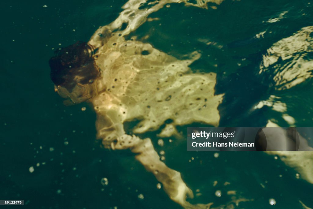 Man floating in water, Odessa, Ukraine
