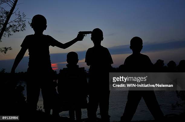 children playing with a toy gun, dnieper river, kiev, ukraine - toy gun stock pictures, royalty-free photos & images