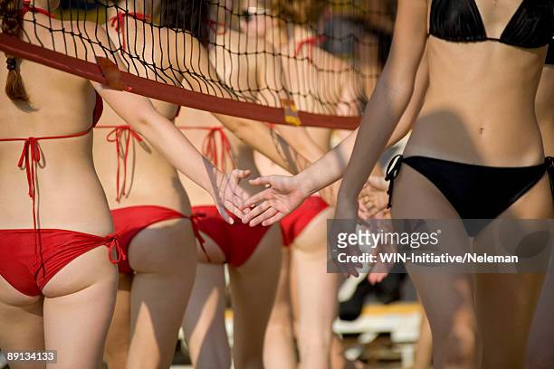 mid section view of a group of teenage volleyball players shaking hands with opponents before start, dnieper river, kiev, ukraine - girls beach volleyball stock pictures, royalty-free photos & images