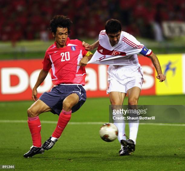 Myung Bo Hong of South Korea pulls the shirt of Hakan Sukur of Turkey during the FIFA World Cup Finals 2002 Third Place Play-Off match played at the...