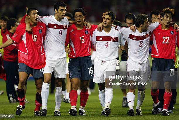 Turkey and South Korea players embrace each other after the FIFA World Cup Finals 2002 Third Place Play-Off match played at the Daegu World Cup...