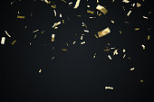 Golden confetti isolated on black background. 3D rendered illustration.
