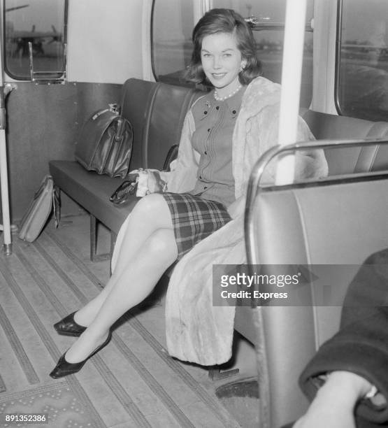 British actress Dawn Addams on a shuttle bus at Haethrow Airport, 10th January 1963.