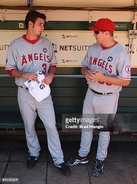 Robb Quinlan and Brandon Wood of the Los Angeles Angels of Anaheim get ready in the dugout before the game against the Oakland Athletics at the...