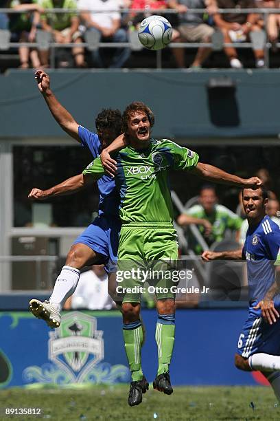 Roger Levesque of Seattle Sounders FC goes up for the header against Juliano Belletti of Chelsea FC during the game on July 18, 2009 at Qwest Field...