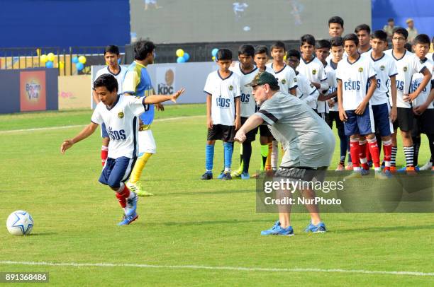 Argentine footballer Diego Maradona gestures during a football workshop with school students in Barasat, around 35 Km north of Kolkata on December...