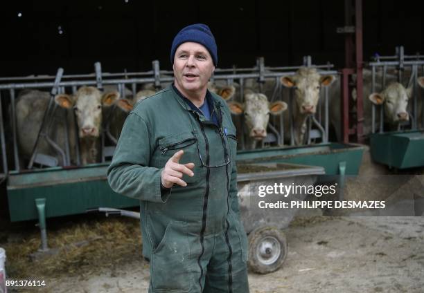 French farmer Didier Caverot, poses with his cattle in his farm in Senailly, eastern France, on December 5, 2017. The documentary "Oser" , produced...