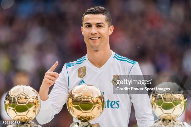 Cristiano Ronaldo of Real Madrid poses for photos with his FIFA Ballon Dor Trophies during the La Liga 2017-18 match between Real Madrid and Sevilla...