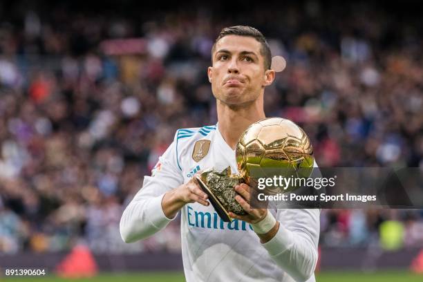 Cristiano Ronaldo of Real Madrid poses for photos with his FIFA Ballon Dor Trophies during the La Liga 2017-18 match between Real Madrid and Sevilla...