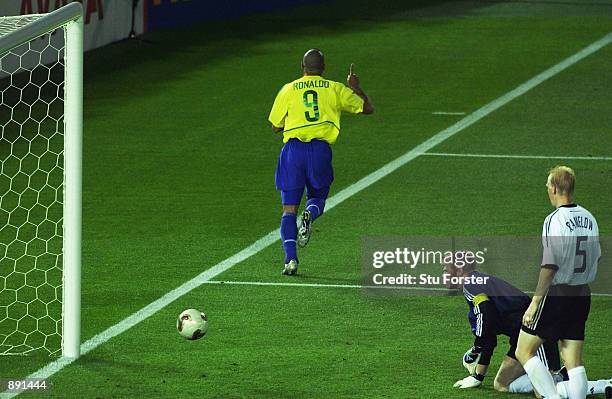 Ronaldo of Brazil celebrates scoring the first goal past goalkeeper Oliver Kahn of Germany during the World Cup Final match played at the...