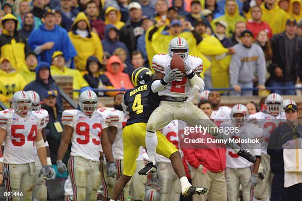 Safety Michael Doss of the Ohio State Buckeyes intercepts the ball over wide receiver Marquise Walker of the Michigan Wolverines during the Big Ten...