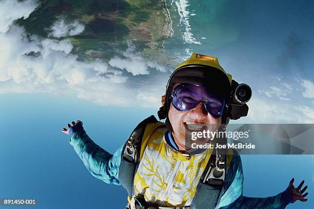 skydiver falling upside-down, camera attached to helmet - skydiving stock-fotos und bilder