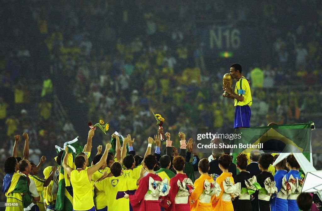 Cafu on the podium celebrates with the World Cup trophy