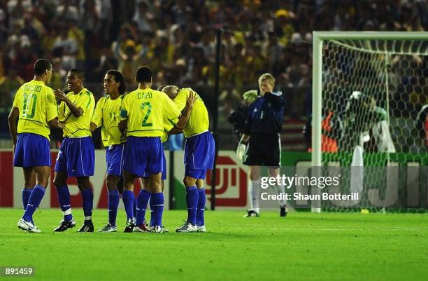 Brazilian players celebrate after Ronaldo scored past dejected goalkeeper Oliver Kahn of Germany during the World Cup Final match played at the...