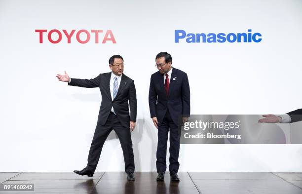 Akio Toyoda, president of Toyota Motor Corp., left, and Kazuhiro Tsuga, president of Panasonic Corp., attend a joint news conference in Tokyo, Japan,...