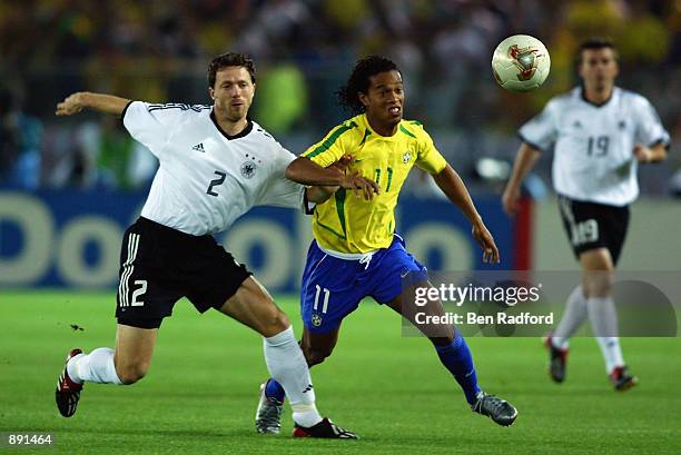 Ronaldinho of Brazil is challenged by Thomas Linke of Germany during the Germany v Brazil, World Cup Final match played at the International Stadium...