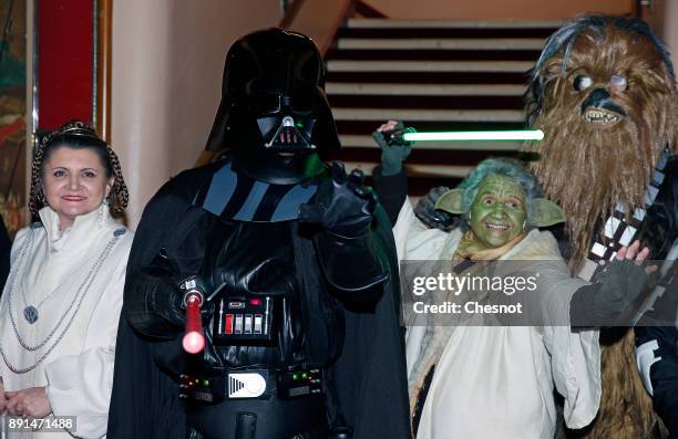 People dressed in character costumes from Star Wars series, princess Leia, Darth Vader, Yoda and Chewbacca pose prior to the public screening of...