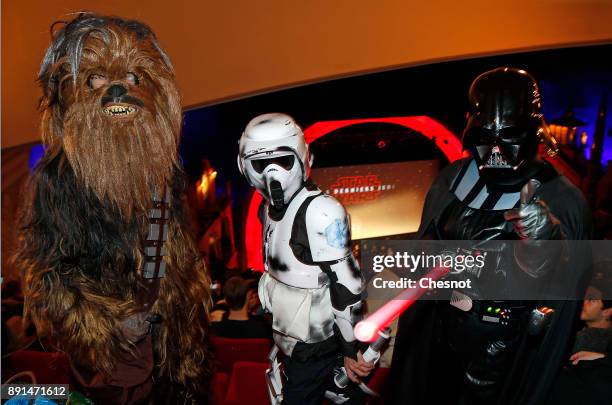 People dressed in character costumes from Star Wars series, Chewbacca, stormtrooper and Darth Vader pose prior to the public screening of 'Star Wars:...