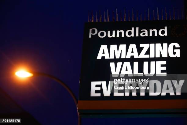 Poundland sign sits on display at an entrance to a Poundland Group Ltd. Discount retail store, operated by Steinhoff International Holdings NV, in...