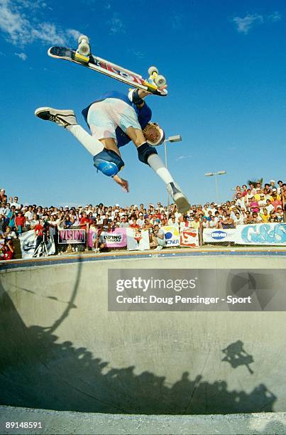 Tony Hawk, riding for Powell Peralta, does an airwalk air above the keyhole pool during competition as the National Skateboarding Association event...