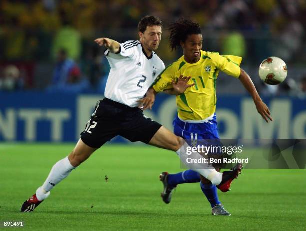 Ronaldinho of Brazil is challenged by Thomas Linke of Germany during the Germany v Brazil, World Cup Final match played at the International Stadium...