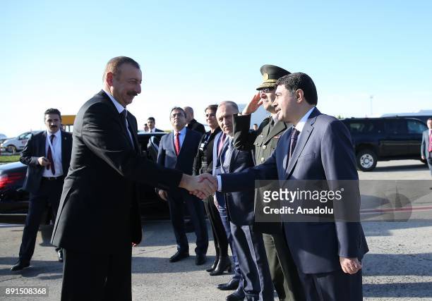 President of Azerbaijan Ilham Aliyev shakes hands with Governor of Istanbul Vasip Sahin ahead of his departure after attending the extraordinary...