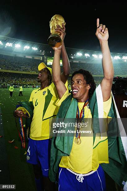 Roque Junior and Ronaldinho of Brazil lift the trophy after the Germany v Brazil, World Cup Final match played at the International Stadium Yokohama...