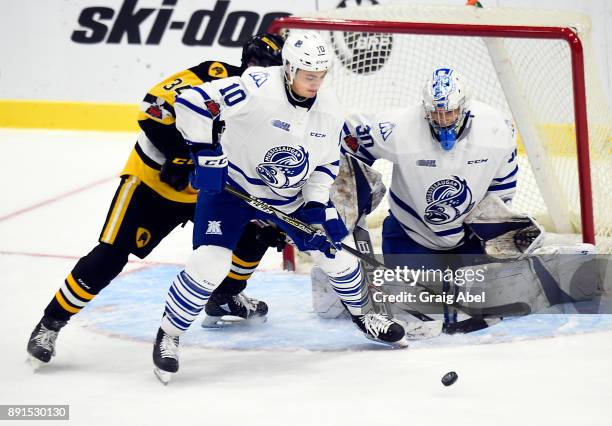 Merrick Rippon and goalie Emanuel Vella of the Mississauga Steelheads battle for the puck with Arthur Kaliyev of the Hamilton Bulldogs during game...