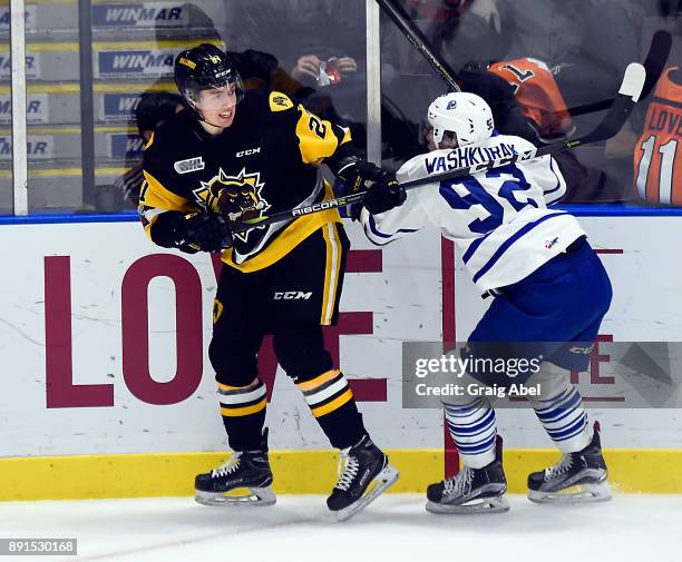 Keean Washkurak of the Mississauga Steelheads battles with Riley McCourt of the Hamilton Bulldogs during game action on December 10, 2017 at Hershey...