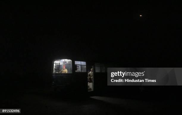 Beneath a rising moon, the Police official on duty in their bus at the anti-cow smuggling Mobile Police Post at Amalaki , at Bhiwadi, on intervening...