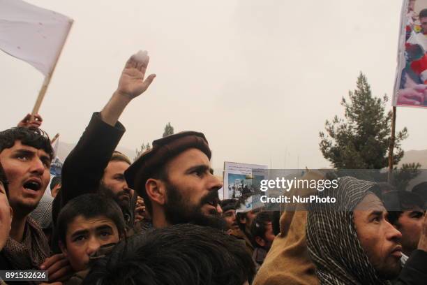 Afghan demonstrators hold placards during a protest against the US and Israel in Badakhshan province on 13 December 2017. Afghans are demonstrating...