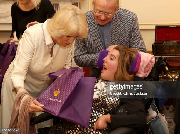 Camilla, Duchess of Cornwall is seen with a child from Helen & Douglas House and Roald Dhal's Marvellous Children's Charity decorating the Clarence...