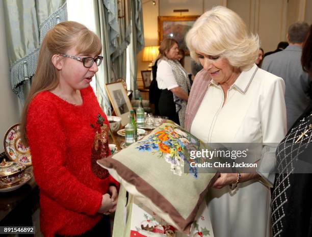 Camilla, Duchess of Cornwall is seen with members from Helen & Douglas House and Roald Dhal's Marvellous Children's Charity decorating the Clarence...