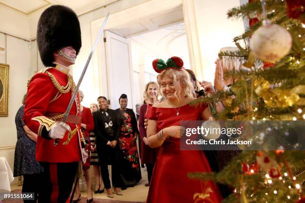 Royal guard welcomes a member from Helen & Douglas House and Roald Dhal's Marvellous Children's Charity during her visit to Clarence House on...